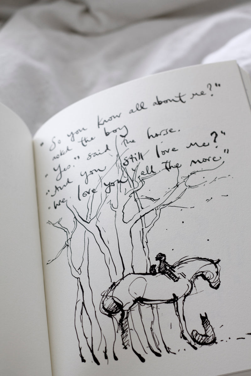 An open Charlie Mackesy | The Boy, The Mole, The Fox and The Horse book.