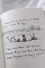An open Charlie Mackesy | The Boy, The Mole, The Fox and The Horse book with a drawing of a polar bear.