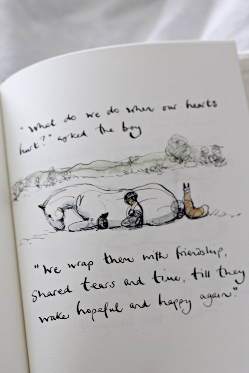 An open Charlie Mackesy | The Boy, The Mole, The Fox and The Horse book with a drawing of a polar bear.