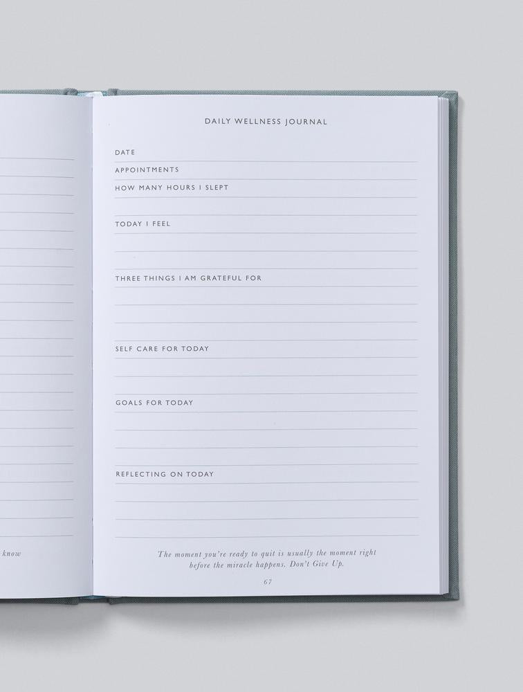 Close-up of a daily wellness journal page with prompts to fill in