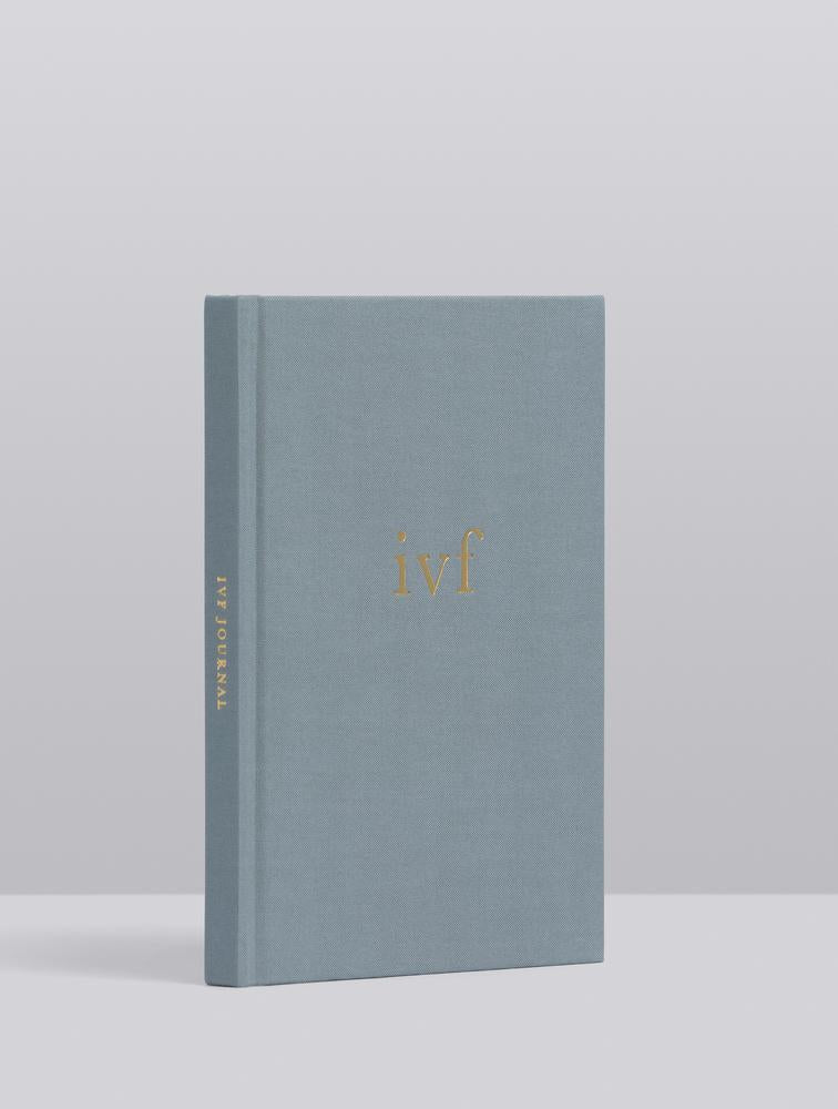 IVF Journey Journal standing upright, showing the grey linen cover and spine