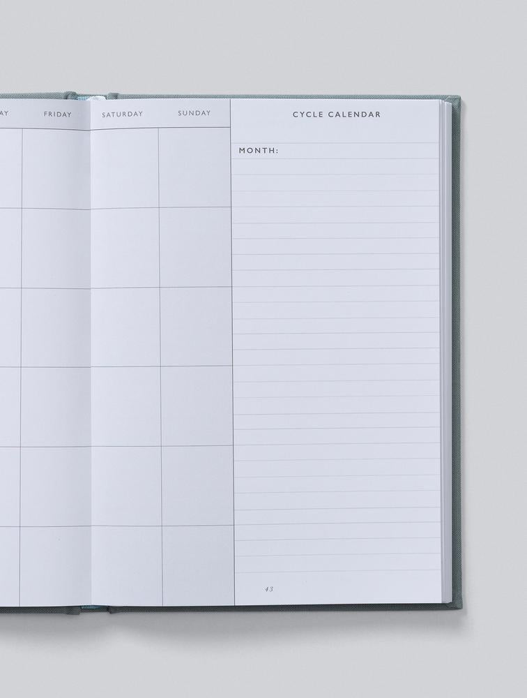 Open journal showing a cycle calendar with a notes column