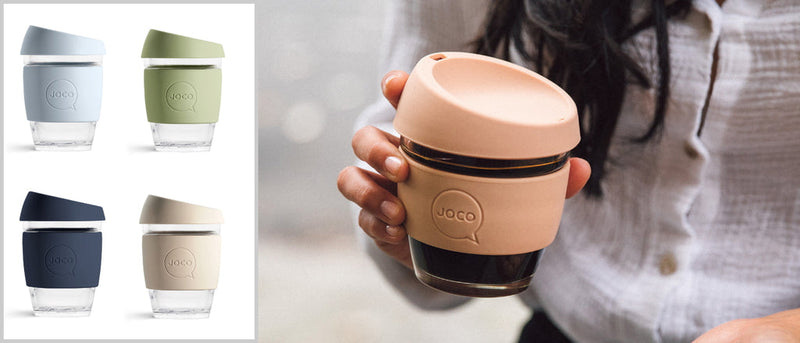 A woman is holding a Joco Cups | Takeaway Cup - 12oz with different colored lids.