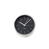 A minimalist Karlsson alarm clock on a white background.