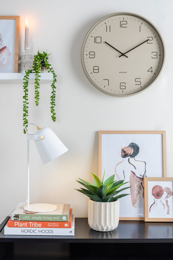Scandinavian design clock, Karlsson Lofty Wall Clock - Grey (40cm), hangs on wall alongside a picture and plant.