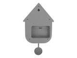 A Modern Scandinavian cuckoo clock with a small hole in it.