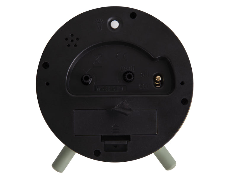 A minimalist Karlsson Alarm Index in green on a stand with a Scandinavian aesthetic.