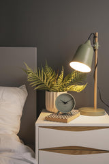 A minimalistic Karlsson Alarm Index with a green aesthetic on a bedside table.