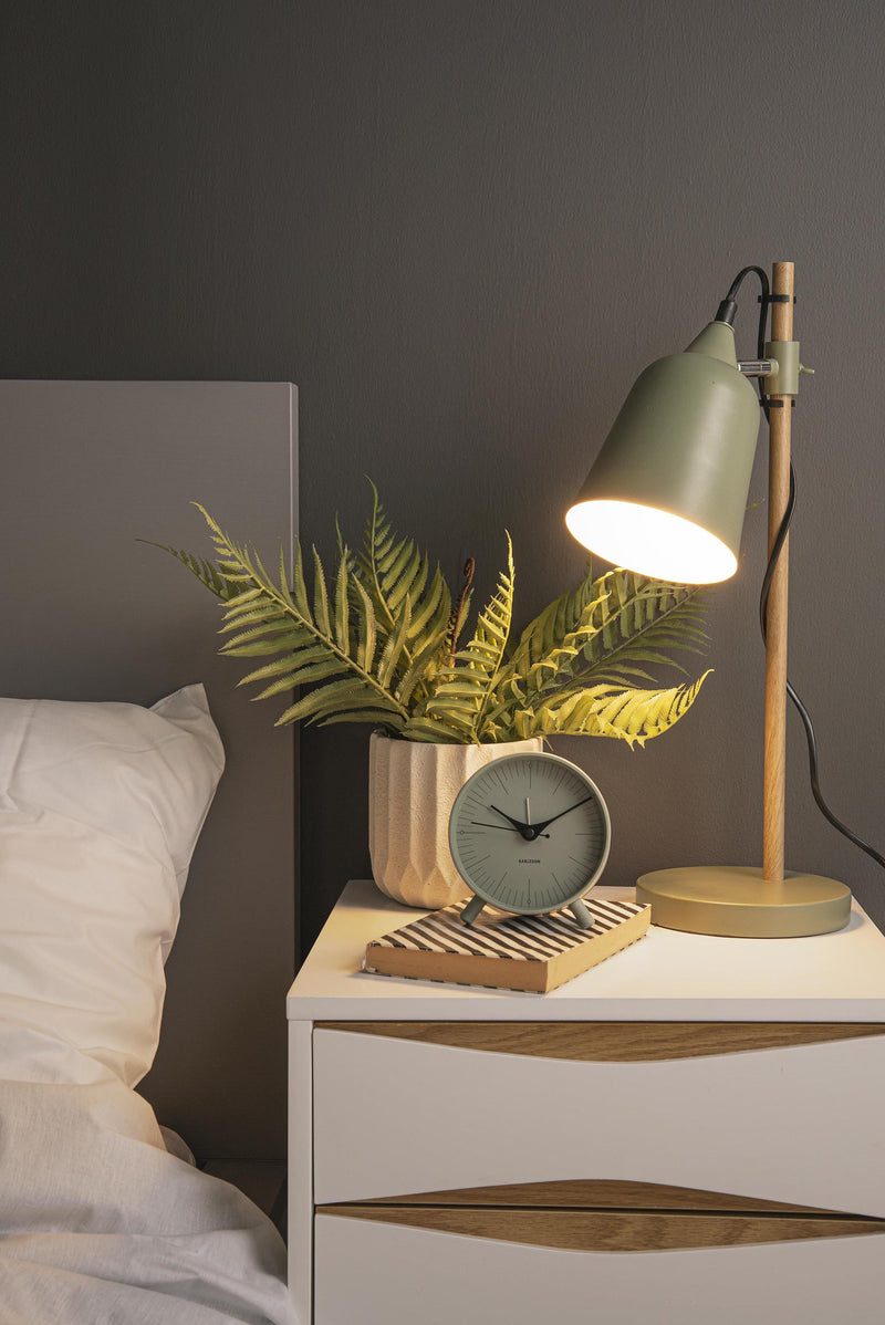 A minimalistic Karlsson Alarm Index with a green aesthetic on a bedside table.