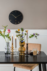 A table adorned with the elegant Charm Wall Clock - Various Colours by Karlsson, accompanied by beautiful candles and flowers.