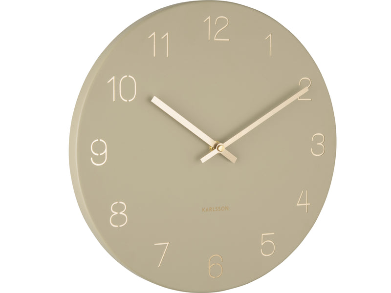 A round Karlsson Charm Wall Clock - Various Colours with engraved gold numbers on a white background.