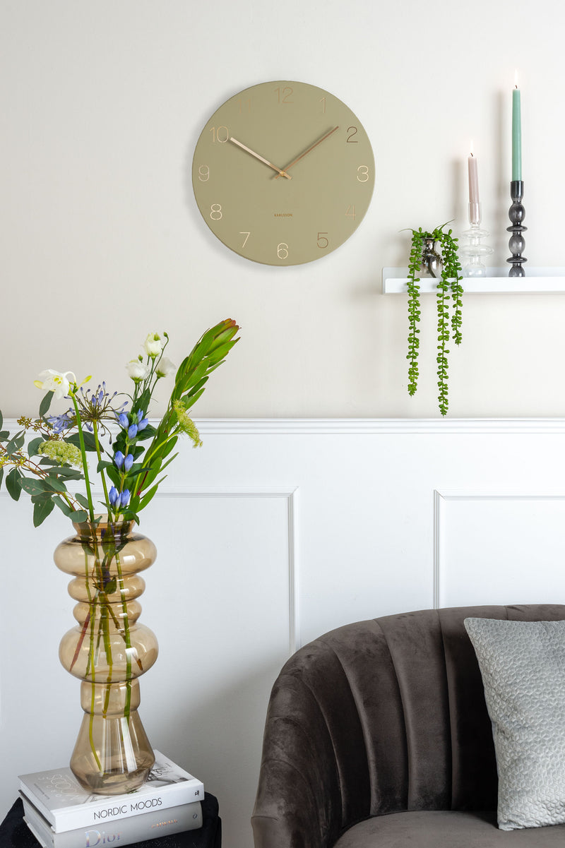 A living room with a grey couch and a Karlsson Charm Wall Clock - Various Colours.