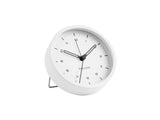 A white Tinge Alarm Clock - White sitting on a white surface.