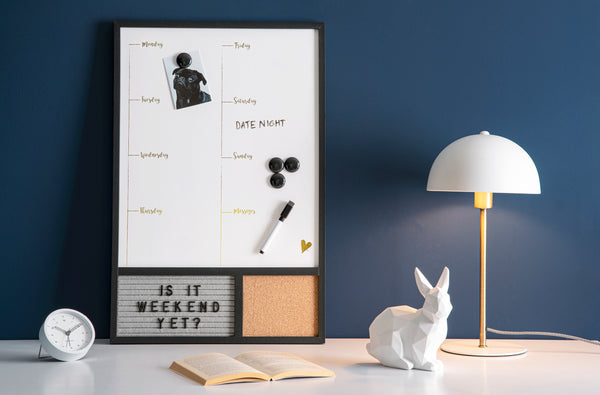 A desk with a white board, a lamp and a bunny equipped with the Karlsson Tinge Alarm Clock - Black.