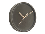 A luxurious Karlsson Lush Velvet Wall Clock - Grey (30cm) with gold hands on a velvet wall.