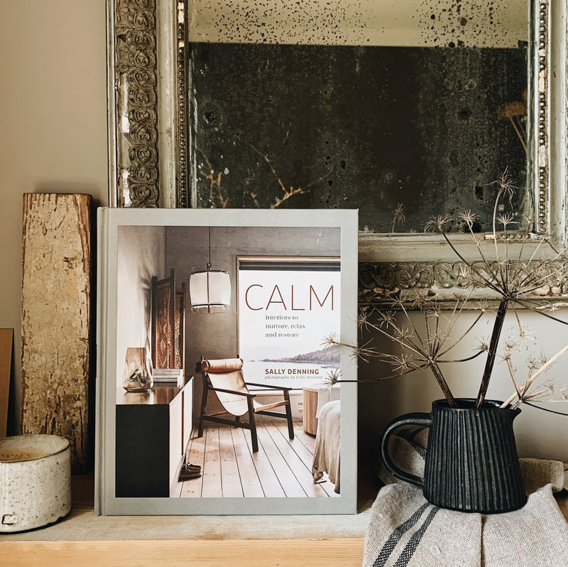 A Calm | Interiors to Nurture, Relax and Restore | Sally Denning book sits on a mantle.