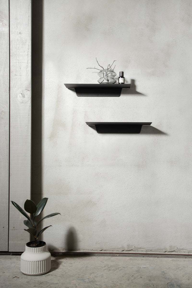 Two Made of Tomorrow FOLD Ledge 450mm ∙ Black shelves on a wall next to a potted plant.