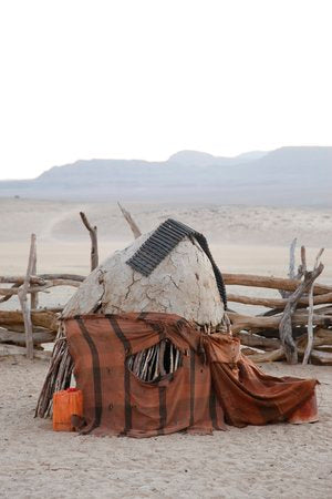 Home book page spread showing an adobe hut