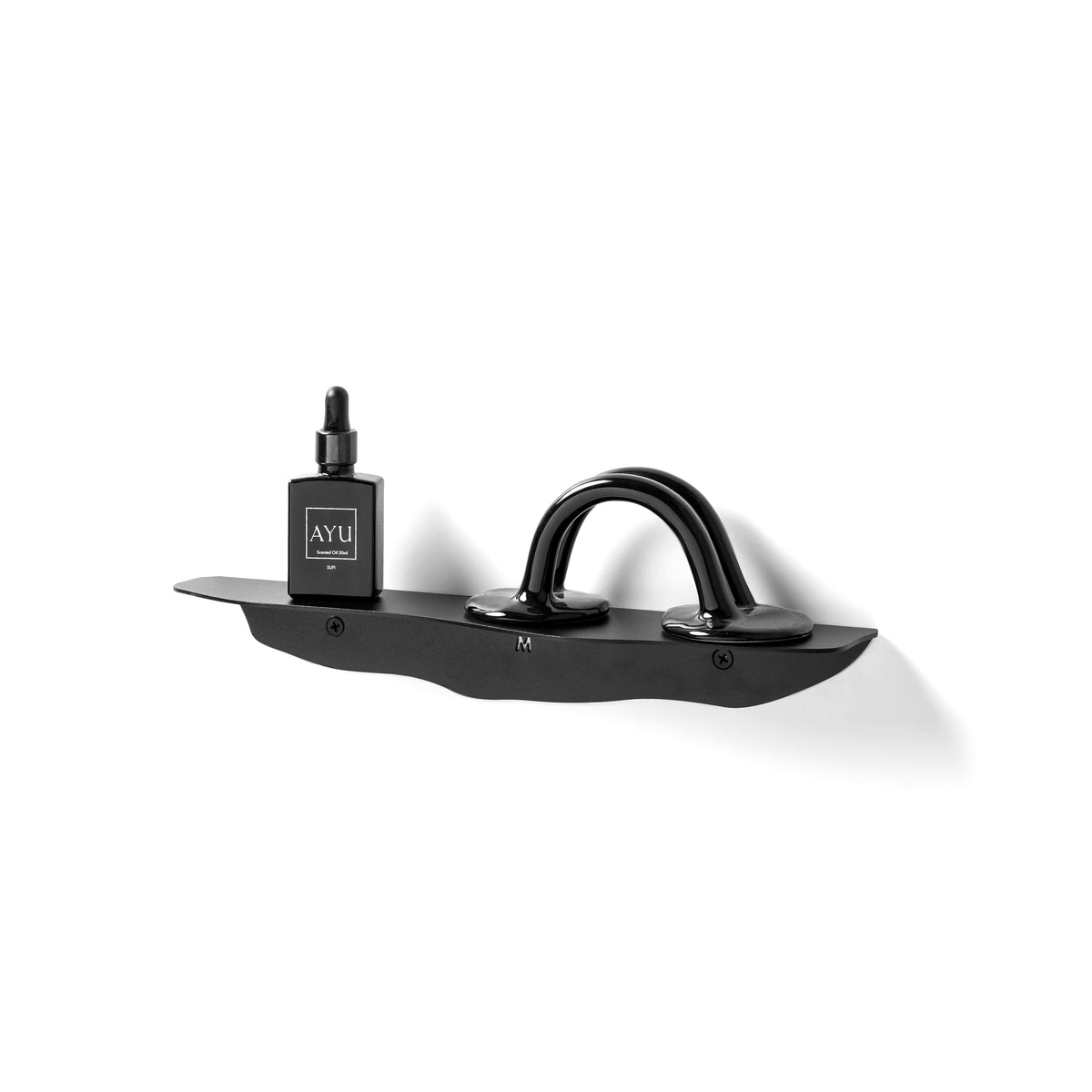 Black wavy shelf angled from the left, holding a small dark bottle and a looping sculptural object