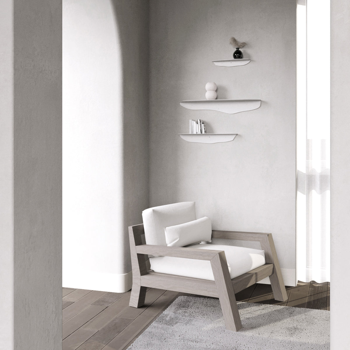 Three white wavy shelves in the same arched plaster alcove above a pale timber armchair