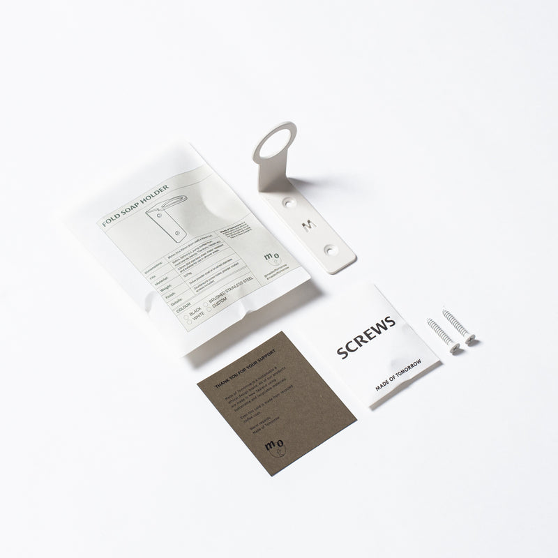 A small package with several FOLD Bottle Holders ∙ White by Made of Tomorrow on a white surface.
