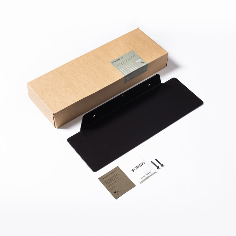 A "Made of Tomorrow" branded FOLD Ledge 450mm ∙ Black box with a business card in it.