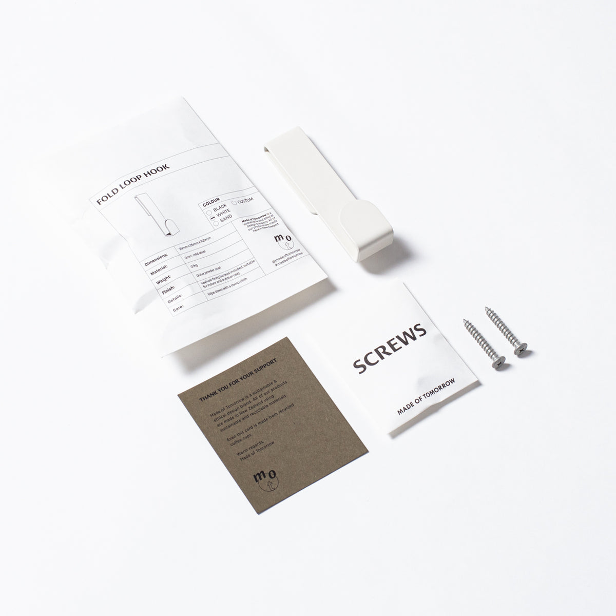 A Made of Tomorrow Fold Loop Hook - White package with a screwdriver and a pair of scissors.