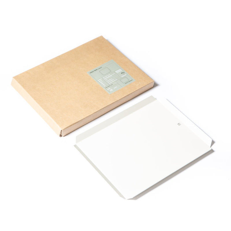 A water-resistant FOLD Tray ∙ White (Large) with a white paper inside, made by Made of Tomorrow.