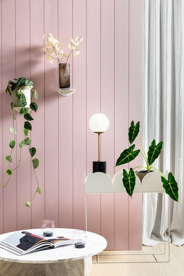 A pink living room with plants and a Made of Tomorrow FOLD ROUND SHELVES (SET OF 2) - WHITE.