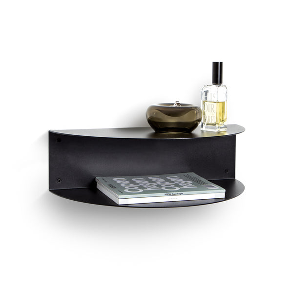 A FOLD Bedside Table ∙ Black with a bottle of Made of Tomorrow perfume on it, perfect for small spaces or limited space.