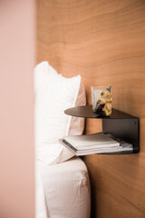 A FOLD Bedside Table ∙ Black with a black shelf and a pillow, perfect for small spaces. (Brand: Made of Tomorrow)