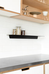 A white kitchen with a black Made of Tomorrow FOLD Ledge 900mm ∙ Black shelf.