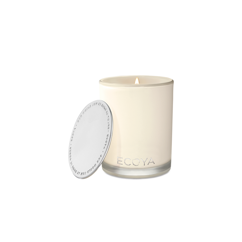 A designer Ecoya Madison Jar Soy Candle with a delightful fragrance and a sleek white lid, showcased on a contrasting black background.