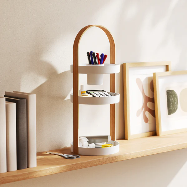 Bellwood organiser holding pens and pencils on a timber shelf beside framed prints