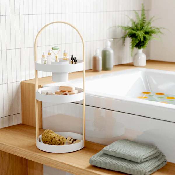A bathroom with an Umbra BELLWOOD COSMETIC ORGANIZER for makeup brushes and cosmetics.