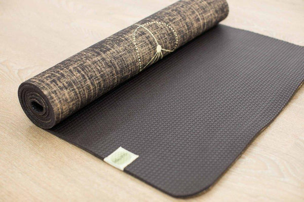 A Yogatribe | Organic Jute 100% Eco Yoga Mat on top of a non-toxic wooden floor.