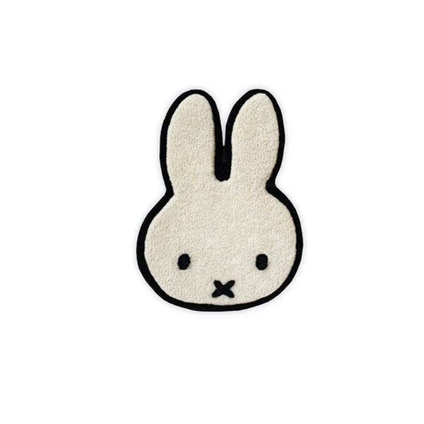 A white bunny with black eyes made from New Zealand wool on a GoodWeave labeled WALL RUG MIFFY WHITE by MAISON DEUX.