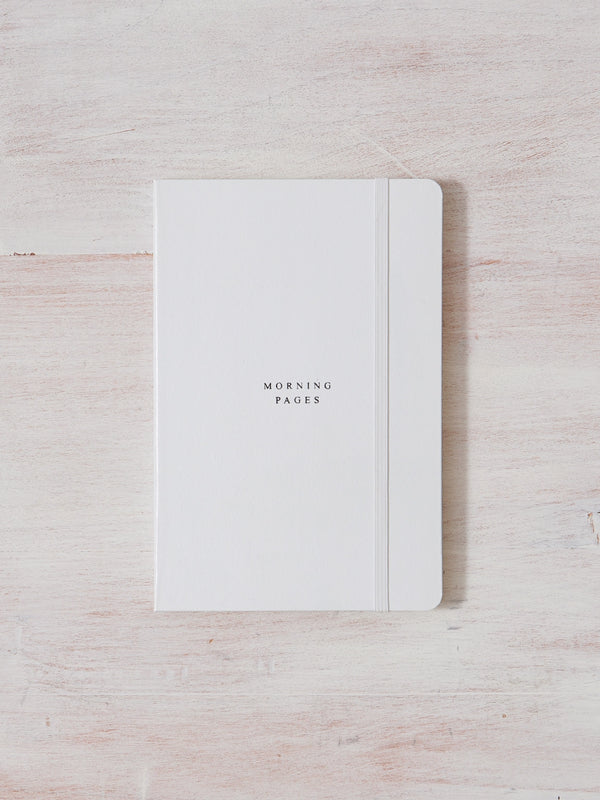 Morning Pages — Journal produced by Thought Catalog on top of a wooden table.