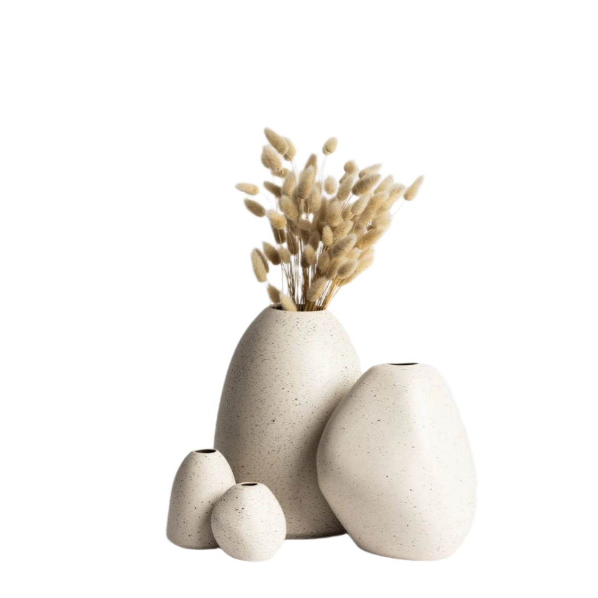 Three white Ned Collections Harmie vases on a white surface.