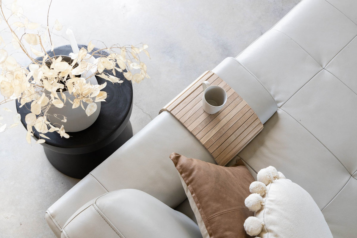 Ned Collections Arm Chair Side Rest styled with a coffee table and a vase