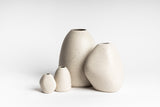 Three HARMIE Pebble Vases - Natural by Ned Collections on a white surface, hand-crafted by Vietnamese artisans.