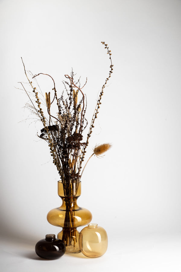 A Ned Collections Donny Vase displaying a bunch of dried flowers from the Glassware Range.
