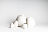A collection of hand-crafted HARMIE Pebble Vases by Vietnamese Artisans from Ned Collections placed on a white background.