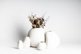 A collection of Great Harmie Vases - White / Natural crafted by Vietnamese artisans, displayed on a white surface.