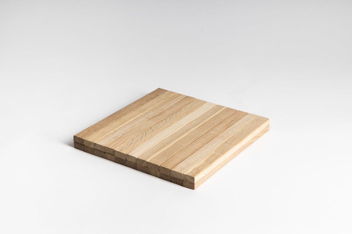 Ned Collections armchair side rest tray shown rolled to show its flexible slatted construction