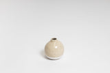 A small beige Charlie Vase from the Ned Collections on a white surface.