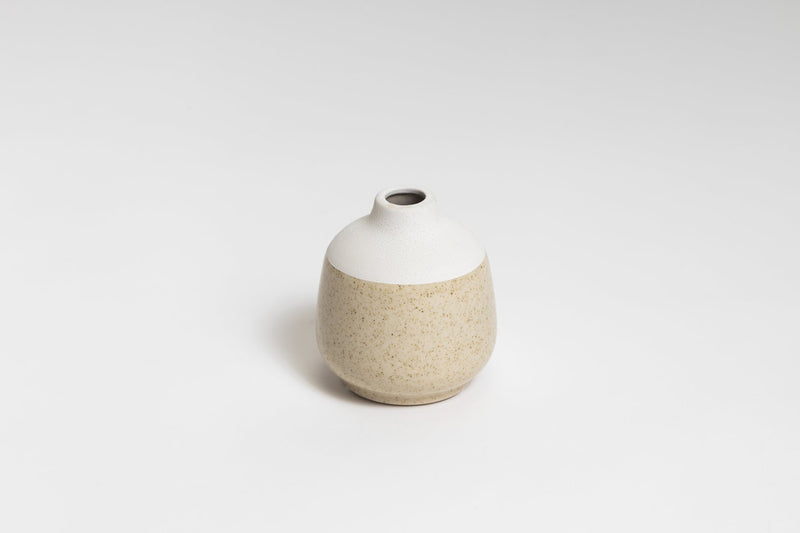 A small white and beige Charlie vase on a white surface from the Ned Collections range.
