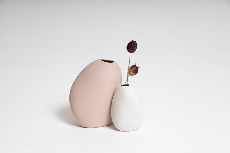 Two Harmie Vase - Seed Grey, created by Vietnamese artisans, featuring organic seed-like shapes, displayed on a white surface.