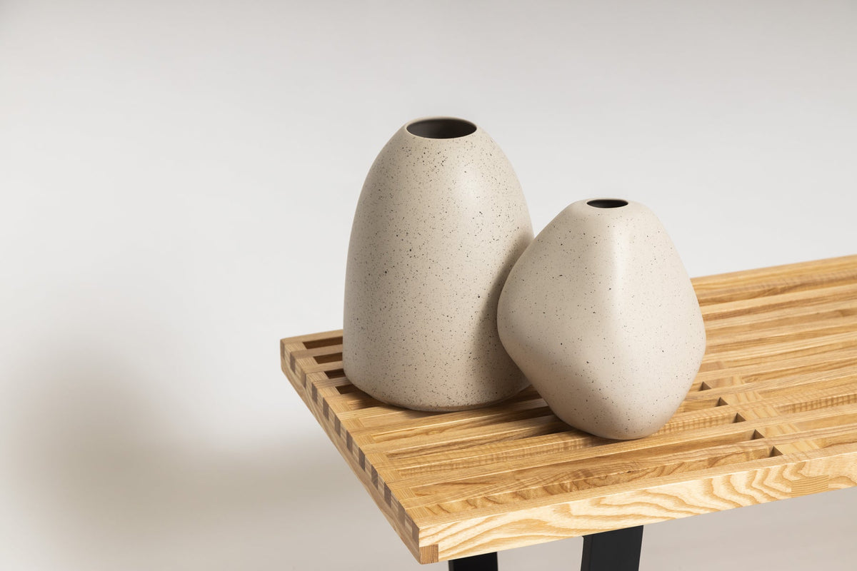 Two Harmie Vases sitting on a wooden bench, available as a SPECIAL ORDER ITEM from Ned Collections.