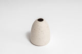 The HARMIE Pebble Vase - Natural, hand-crafted by Vietnamese artisans, is a stunning white vase with a unique hole design.